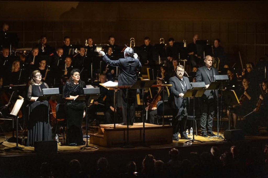 Soloists and conductor performing Verdi Requiem with full orchestra and chorus